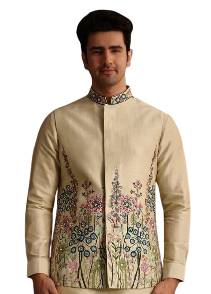 Man wearing an embroidered cream-colored traditional jacket with floral designs.